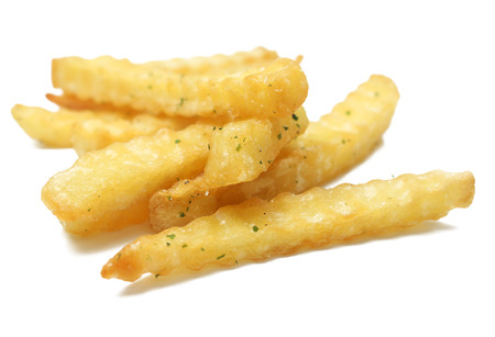 a pile of appetizing french fries on a white backgroundの写真素材