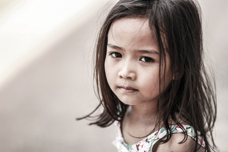 Asian girl Sitting at the playground And joylessの写真素材