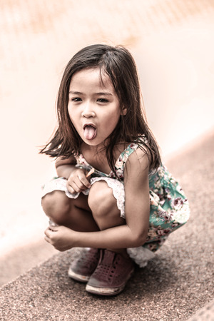 Portrait of an adorable baby girl with tongue sticking outの写真素材