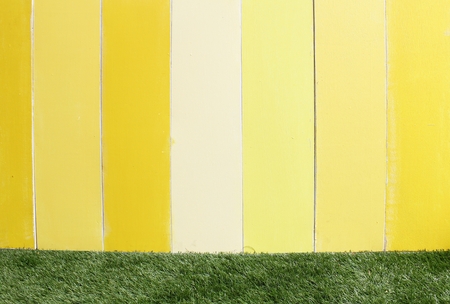 Yellow wooden wall and grassの写真素材