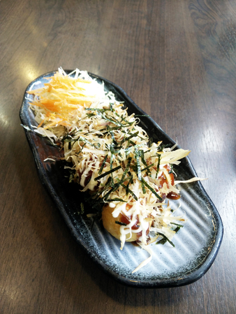 takoyaki japanese octopus balls on black dishの写真素材