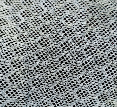 The ivy on the wire mesh against the sky backdropの写真素材