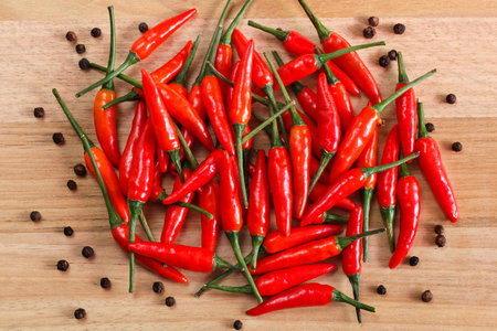 Red Chili pepper with allspice on wooden table