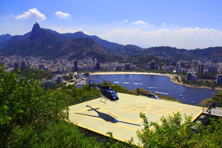 RIO DE JANEIRO - FEBRUARY 26  Helicopter lands on helipad of Sugarloaf in front of Guanabara bay, Corcovado and Christ the Redeemer on February 26,2014のeditorial素材