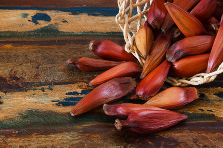 Pinhao  brazilian pine  in wicker basket on wooden table  Selective focus  Copy spaceの写真素材