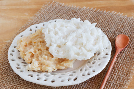 Coconut candy cocada on sackcloth  on wooden table  Selective focus