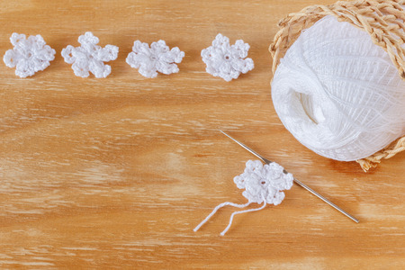 White crochet snowflakes for Christmas decoration on wooden table with copy space. Selective focusの写真素材