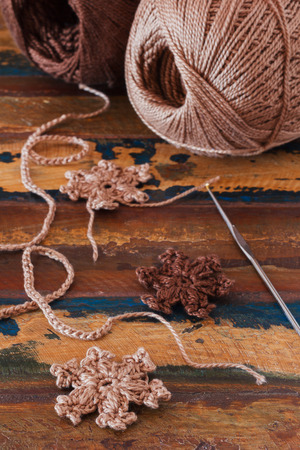 Brown crochet snowflakes for Christmas and New year decoration. Selective focusの写真素材