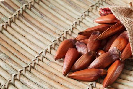 Pinhao - brazilian pine in sackcloth bag on wooden board with copy space. Selective focusの写真素材