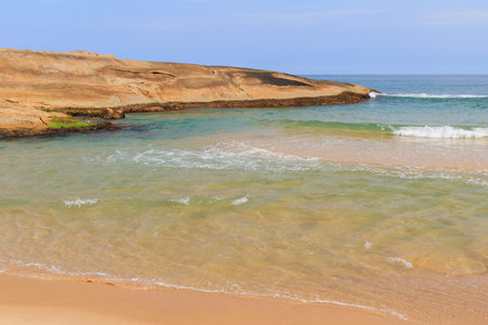 Part of the rock on beach Praia do Cepilho with transparent sea with waves, Trindade, Paraty, state...