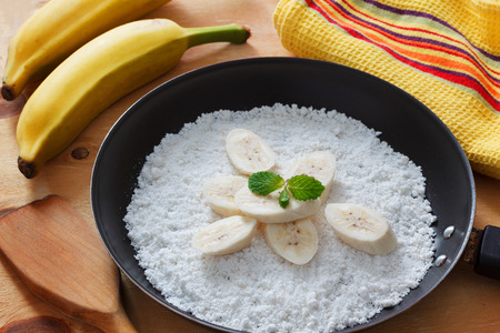 Casabe (bammy, beiju, bob, biju) - flatbread made from cassava (tapioca) with banana on pan. Selective focus. Copy spaceの写真素材