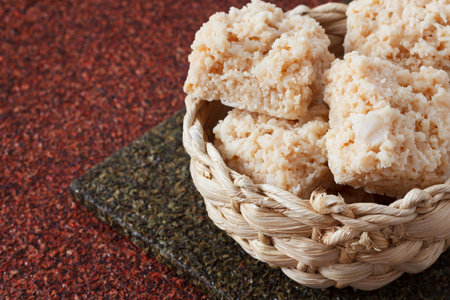 Coconut candy cocada in wicker basket. Selective focus