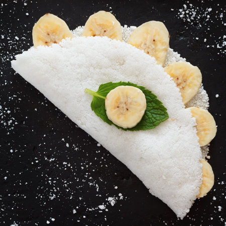Casabe (bammy, beiju, bob, biju) - flatbread made from cassava (tapioca) with banana and cinnamon on pan. Selective focus. Copy spaceの写真素材