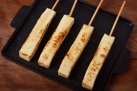 Brazilian traditional cheese queijo coalho on pan on wooden background; Selective focusの写真素材