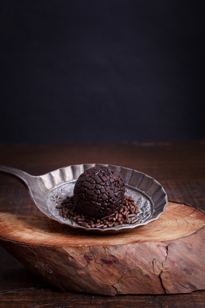 Brazilian chocolate truffle bonbon brigadeiro on wooden table. Selective focus. Copy spaceの写真素材