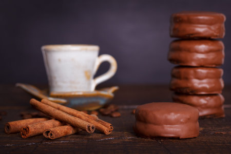 Brazilian honey cookie wihn chocolate - pao de mel with cup of coffee on wooden background. Selective focusの写真素材