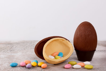 Chocolate egg for Easter on wooden background. Selective focus