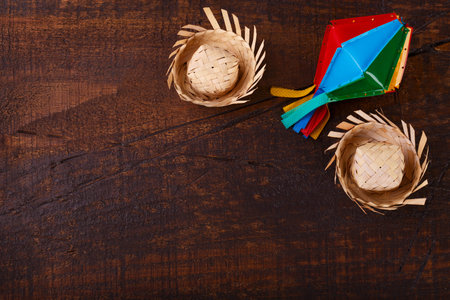 Wooden background with wicker hat for brazilian festivel Festa Junina, copy space