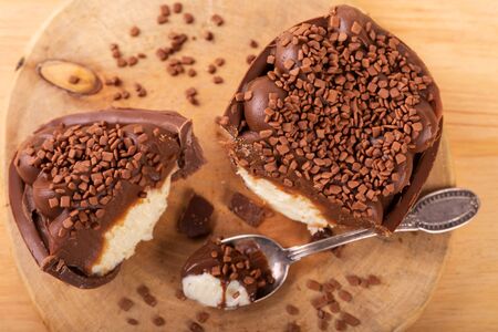 Chocolate egg with filling for Easter on woodenの写真素材