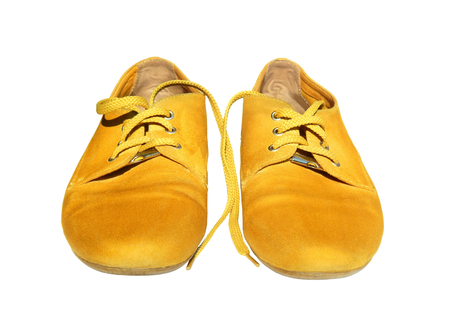 Pair of yellow shoes on white backgroundの写真素材