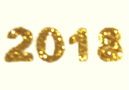Figures 2018 of golden glitter on white background, symbol of New Year, icon. Blurry design element, bokeh lightsの写真素材