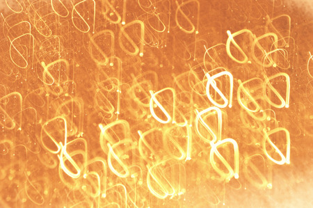 Beautiful defocused festive background in golden colors. Wallpaper, holiday design, blurred motion.の写真素材