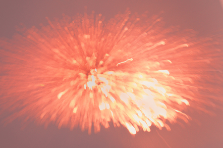 Beautiful defocused festive background in pink gold colors like fireworkの写真素材