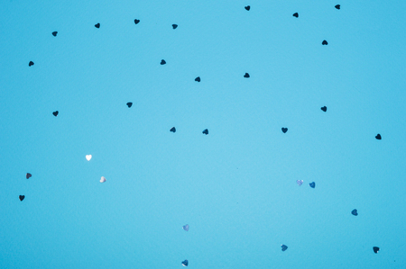 Silver glitter hearts on blue background in vintage colorsの写真素材