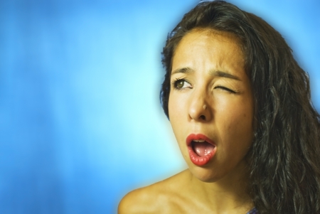 Face of beautiful young woman on blue backgroundの写真素材