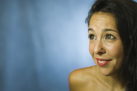 Face of beautiful young woman on blue backgroundの写真素材
