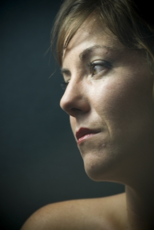 face of young beautiful woman on black backgroundの写真素材