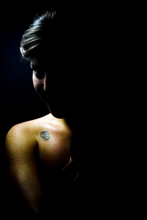 face of young beautiful woman on black backgroundの写真素材