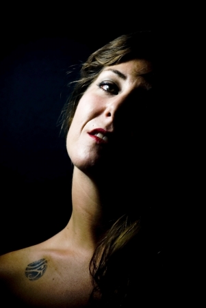 face of young beautiful woman on black backgroundの写真素材