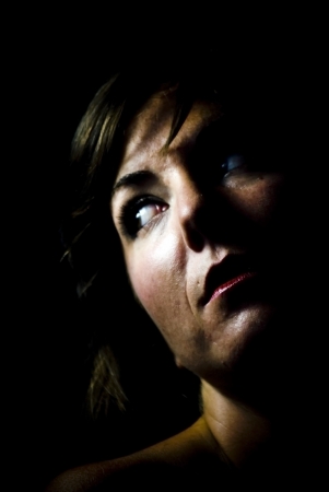 face of young beautiful woman on black backgroundの写真素材