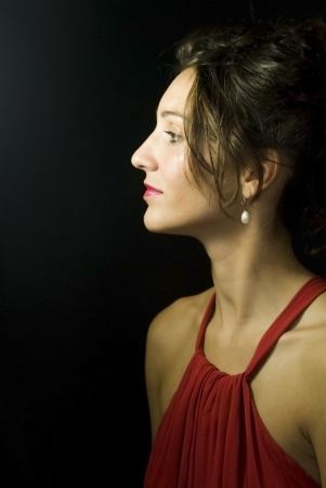 Portrait of beautiful young woman on black backgroundの写真素材