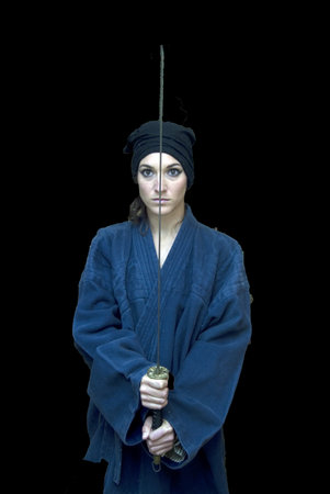 Portrait of a beautiful woman with japanese clothing wielding a katana