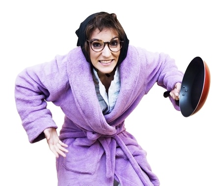 Old woman with frying panの写真素材