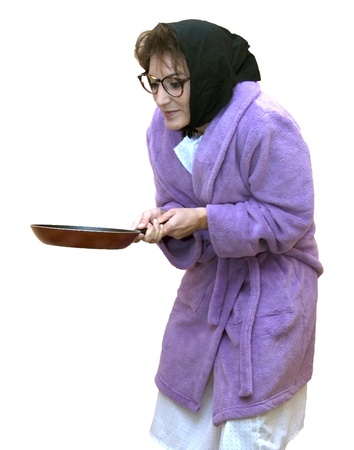 Old woman with frying panの写真素材