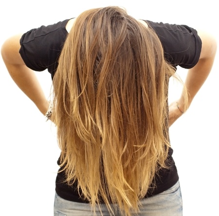 Portrait of young beautiful woman with black shirt moving hair on white backgroundの写真素材