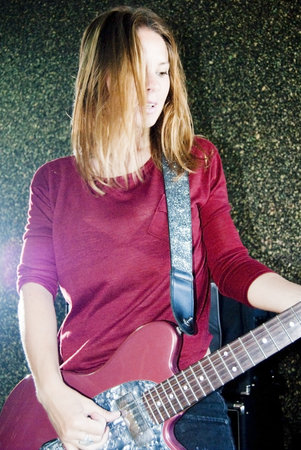 Portrait of young beautiful woman playing guitarの写真素材