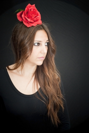 Beautiful woman with typical dress of flamenco in Spain on black backgroundの写真素材