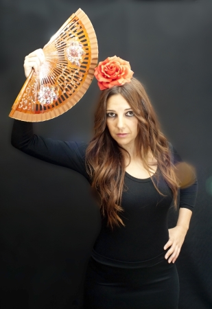 Beautiful woman with typical dress of flamenco in Spain on black backgroundの写真素材