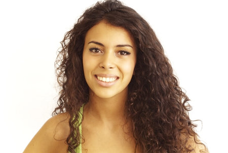 Portrait of a young  happy woman with green shirt over white backgroundの写真素材