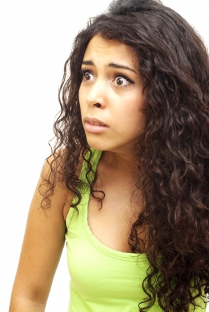 Portrait of a young  sad woman with green shirt over white backgroundの写真素材