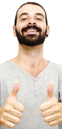 Handsome guy with beard and gray shirt and her thumb up on white backgroundの写真素材