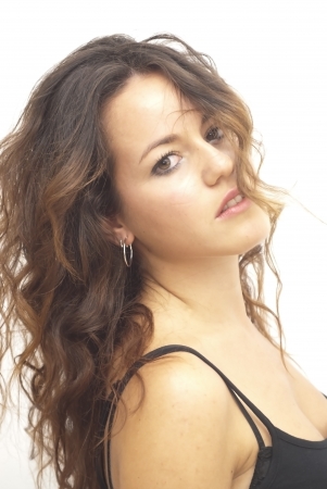 Portrait of a young  woman with black shirt over white backgroundの写真素材