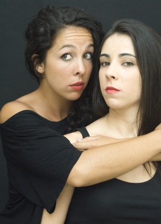 Two beautiful friends embrace one anotherの写真素材