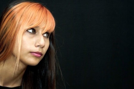 Portrait of an attractive girl on black backgroundの写真素材