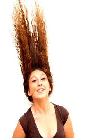 Pretty woman with blue eyes  and her hair moving with the wind on white background