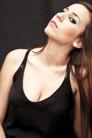 Beautiful Brunette Girl over black backgroundの写真素材